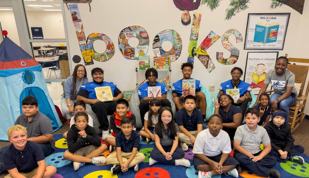 Students reading together during admissions tour